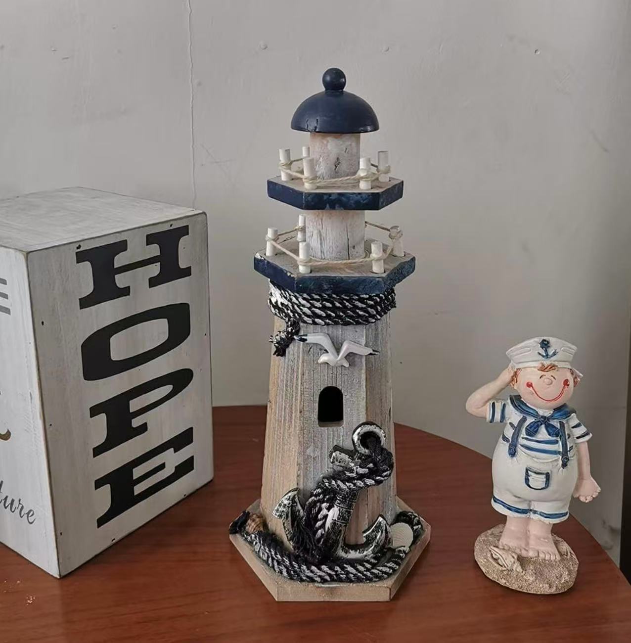 Nautical-themed lighthouse figurine, perfect as a beach-style centerpiece for your bathroom or home decor.